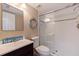 This stylish bathroom features a walk-in shower with new fixtures and a dark vanity with a sink at 1206 Gulf Blvd # C, Indian Rocks Beach, FL 33785