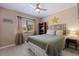 Bright bedroom with a queen-sized bed, a decorative star, and natural light from the window at 1206 Gulf Blvd # C, Indian Rocks Beach, FL 33785