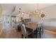 Open-concept dining area with views into a modern kitchen with stainless steel appliances and granite countertops at 1206 Gulf Blvd # C, Indian Rocks Beach, FL 33785