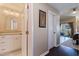 Hallway leading to a bathroom and bedroom with balcony access, showcasing modern finishes at 1206 Gulf Blvd # C, Indian Rocks Beach, FL 33785