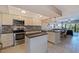 Modern kitchen boasts stainless steel appliances, center island, and breakfast bar overlooking the dining area at 1206 Gulf Blvd # C, Indian Rocks Beach, FL 33785