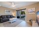 Relaxing living room with tile floors, slider to patio, couch, ceiling fan, and neutral color palette at 1206 Gulf Blvd # C, Indian Rocks Beach, FL 33785