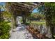 Picturesque park walkway with a pergola, wooden benches, lush foliage, and inviting pathway for relaxing outdoor strolls at 1206 Gulf Blvd # C, Indian Rocks Beach, FL 33785