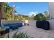 Private outdoor patio featuring pavers, a grill, and comfortable seating with mature landscaping at 1206 Gulf Blvd # C, Indian Rocks Beach, FL 33785