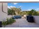 Private outdoor patio featuring pavers, a grill, and comfortable seating with mature landscaping at 1206 Gulf Blvd # C, Indian Rocks Beach, FL 33785