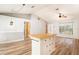 Bright and airy living area with new flooring and a spacious center island for meal prep and entertaining at 12129 Meadow Ln, San Antonio, FL 33576