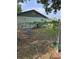 View of the home's back exterior with a fenced yard, providing privacy and security at 125 S Wiggins Rd, Plant City, FL 33566