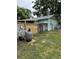 Side view of house showing pool equipment and privacy fence with a grassy yard at 125 S Wiggins Rd, Plant City, FL 33566