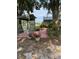 Backyard sitting area with a white rocking chair and brick patio, offering a cozy outdoor retreat at 125 S Wiggins Rd, Plant City, FL 33566