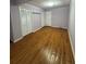 Bedroom featuring hardwood floors, closet and a door at 125 S Wiggins Rd, Plant City, FL 33566
