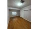 Bedroom featuring hardwood floors, closet and a window at 125 S Wiggins Rd, Plant City, FL 33566