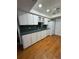 Traditional kitchen with white cabinets, green countertops, and stainless steel sink at 125 S Wiggins Rd, Plant City, FL 33566