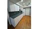 Traditional kitchen with white cabinets, green countertops, and stainless steel sink at 125 S Wiggins Rd, Plant City, FL 33566