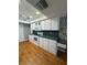 Kitchen featuring a white oven and microwave, white cabinets, and a green countertop at 125 S Wiggins Rd, Plant City, FL 33566