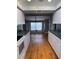 Traditional kitchen with white cabinets, green countertops, and chandelier at 125 S Wiggins Rd, Plant City, FL 33566