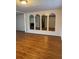 Spacious living room with wood floors and a mirrored wall, adding depth and style to the space at 125 S Wiggins Rd, Plant City, FL 33566