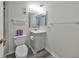 Bathroom with a grey vanity, toilet and tile floors at 1301 Gulf Blvd # 107, Clearwater Beach, FL 33767