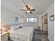Cozy bedroom featuring a ceiling fan, soft lighting, and wood floors at 1301 Gulf Blvd # 107, Clearwater Beach, FL 33767