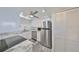 Updated kitchen with stainless steel appliances, granite countertops and bright white cabinetry at 1301 Gulf Blvd # 107, Clearwater Beach, FL 33767