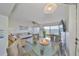 Open floorplan living room featuring ceiling fan, water views and wood floors at 1301 Gulf Blvd # 107, Clearwater Beach, FL 33767