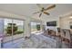 Bright living room featuring large sliding doors to the patio and bay views, creating an indoor-outdoor flow at 1301 Gulf Blvd # 107, Clearwater Beach, FL 33767