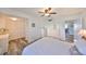 Bright bedroom featuring wood floors, ceiling fan, double closets, and an ensuite bath at 1301 Gulf Blvd # 107, Clearwater Beach, FL 33767