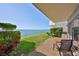 Enjoy waterfront views from the private patio with seating, overlooking lush landscaping and the bay at 1301 Gulf Blvd # 107, Clearwater Beach, FL 33767
