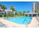 Resort-style pool area featuring sparkling water, ample lounge seating and lush tropical landscaping at 1301 Gulf Blvd # 107, Clearwater Beach, FL 33767