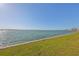 Scenic waterfront view with blue skies, calm water, and lush green shoreline, providing a peaceful setting at 1301 Gulf Blvd # 107, Clearwater Beach, FL 33767