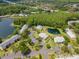 Scenic aerial view of a well-maintained condo complex surrounded by lush landscaping and tranquil ponds at 1400 Pine Glen Ln # B2, Tarpon Springs, FL 34688