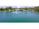 Aerial view of a lake with a water feature fountain in the middle at 1400 Pine Glen Ln # B2, Tarpon Springs, FL 34688