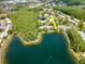 This aerial view highlights the community's beautiful pond and lush surroundings at 1400 Pine Glen Ln # B2, Tarpon Springs, FL 34688