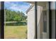 Pond-view showcasing lush greenery, mature trees, and community buildings at 1400 Pine Glen Ln # B2, Tarpon Springs, FL 34688