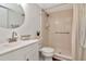 Well-lit bathroom with a sink, toilet, and shower featuring a white tile shower at 1400 Pine Glen Ln # B2, Tarpon Springs, FL 34688
