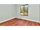 Spacious bedroom with hardwood floors and a window view of lush greenery at 1400 Pine Glen Ln # B2, Tarpon Springs, FL 34688