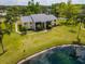 Exterior home view features mature trees, lush lawns and a beautiful pond at 1400 Pine Glen Ln # B2, Tarpon Springs, FL 34688