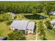 An exterior aerial view of a condo building near a tranquil pond surrounded by lush greenery at 1400 Pine Glen Ln # B2, Tarpon Springs, FL 34688