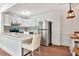 Bright kitchen with white cabinets, stainless steel appliances, an island with white countertops and pendant lighting at 1400 Pine Glen Ln # B2, Tarpon Springs, FL 34688