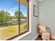 Cozy reading nook with a view of the pond, chair and a pillow is visible at 1400 Pine Glen Ln # B2, Tarpon Springs, FL 34688
