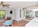 Open living space with hardwood floors and modern furnishings flowing into the adjacent, updated, white kitchen at 1400 Pine Glen Ln # B2, Tarpon Springs, FL 34688