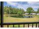 Serene view of the pond and verdant landscaping from the screened patio at 1400 Pine Glen Ln # B2, Tarpon Springs, FL 34688