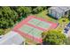 Aerial shot of two tennis courts with green and red surfaces at 1400 Pine Glen Ln # B2, Tarpon Springs, FL 34688