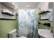 Bathroom features a shell themed shower curtain and matching wall decor accents at 1507 Legion Ln, Indian Rocks Beach, FL 33785