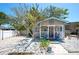 Charming cottage with a front porch, light blue shutters and a quaint compass decoration at 1507 Legion Ln, Indian Rocks Beach, FL 33785