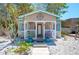 Charming cottage with a front porch, light blue shutters and a quaint compass decoration at 1507 Legion Ln, Indian Rocks Beach, FL 33785