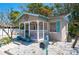 Charming cottage with a front porch, light blue shutters and a mailbox at 1507 Legion Ln, Indian Rocks Beach, FL 33785