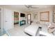 Bright living room with a white sectional sofa, tile flooring, and stylish coastal decor at 1507 Legion Ln, Indian Rocks Beach, FL 33785