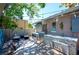 Well-appointed outdoor kitchen features a grill, sink, countertop, and exterior washing machine/dryer at 1507 Legion Ln, Indian Rocks Beach, FL 33785