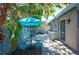 Charming outdoor patio with a dining set, grill, and tropical landscaping for relaxing or entertaining at 1507 Legion Ln, Indian Rocks Beach, FL 33785