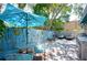 Outdoor patio features a dining set, grill, and tropical landscaping with painted privacy fence at 1507 Legion Ln, Indian Rocks Beach, FL 33785